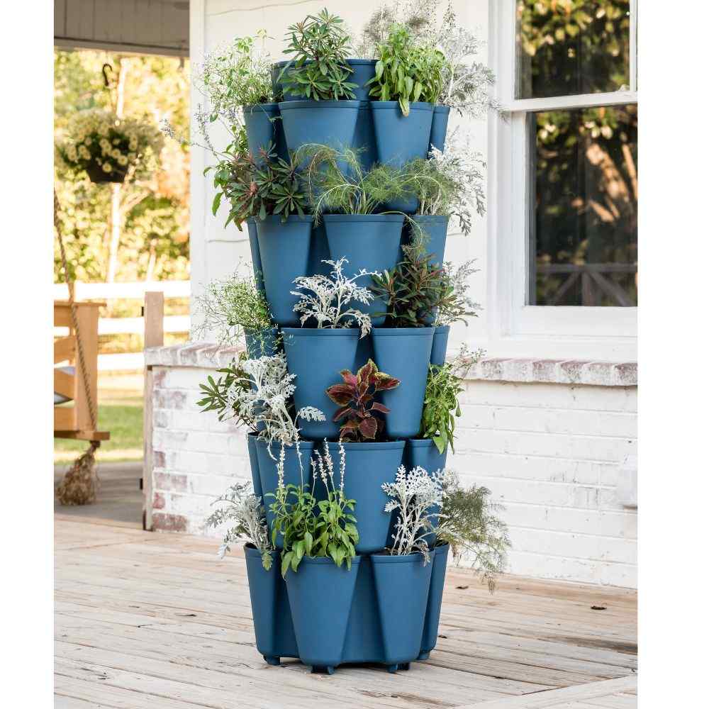  Blue vertical flower planters filled with assorted plants on a wooden patio