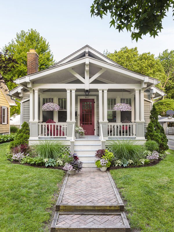 Home with coordinated plants in the landscape and pots