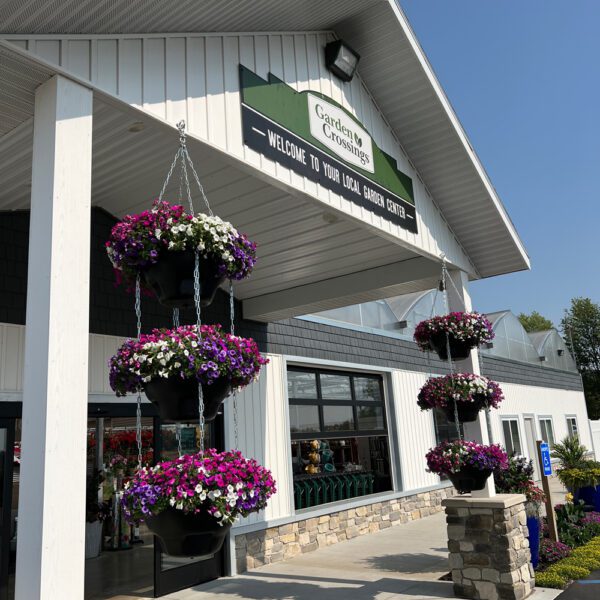 front entrance of the garden center with hanging baskets on either side of the entrance